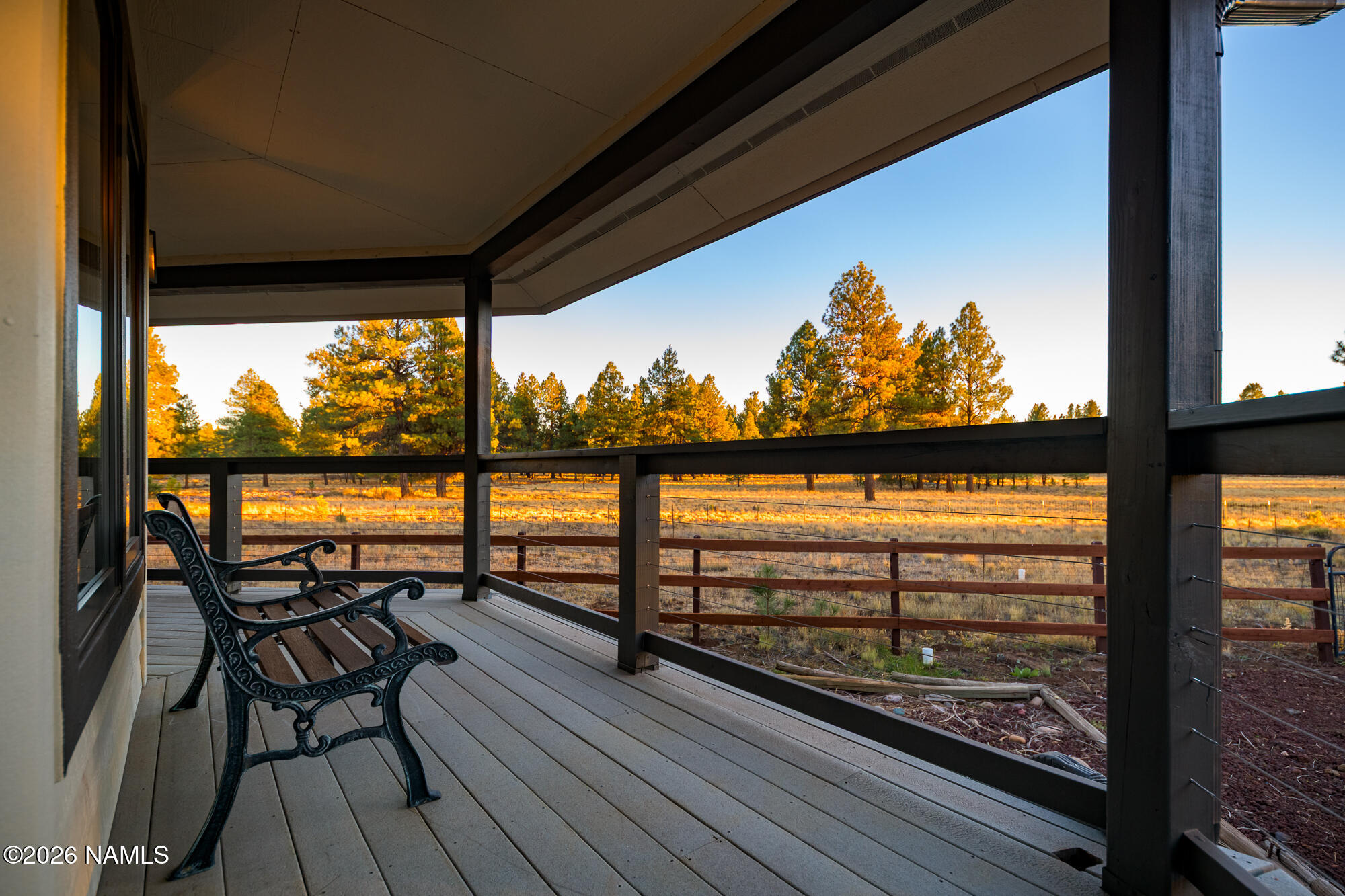 4540 Forest Ranches Loop Parks, AZ 86018 - Photo 41 of 60 a view of a balcony with furniture and wooden floor