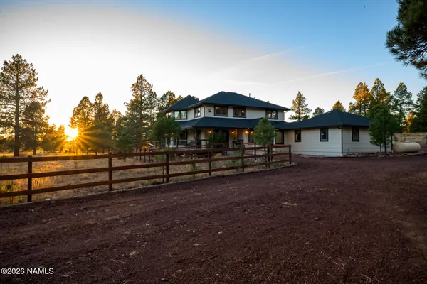a aerial view of a house with a yard and lake view