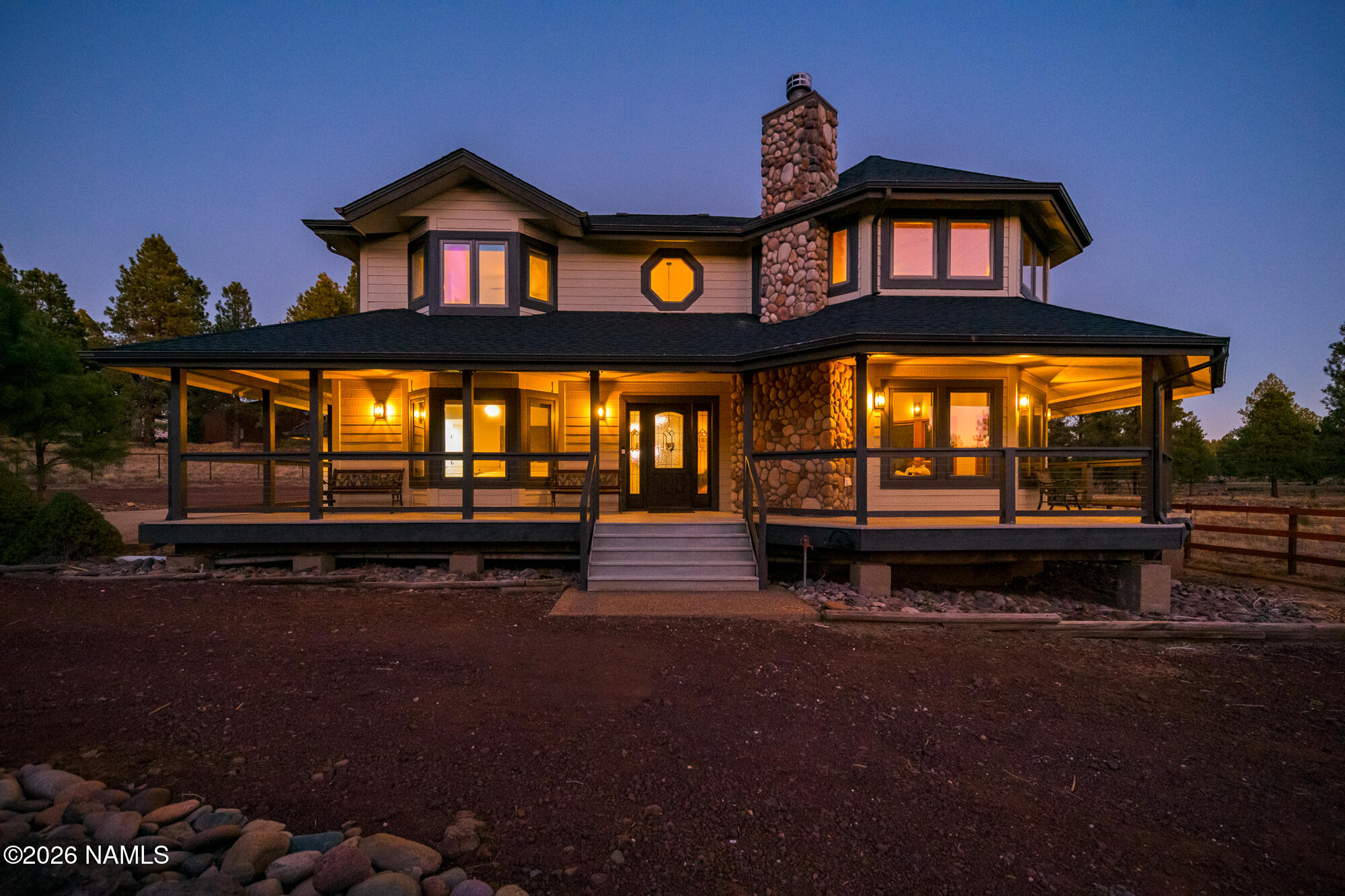 4540 Forest Ranches Loop Parks, AZ 86018 - Photo 48 of 60 a view of a big house with a large window and a pathway