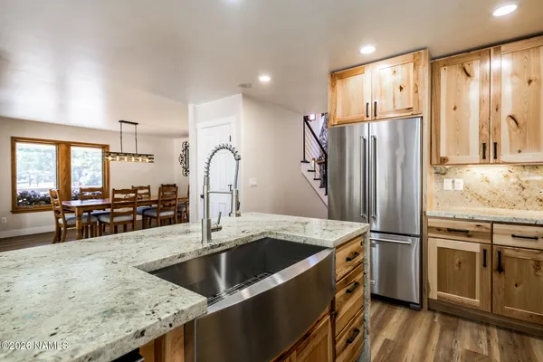 a kitchen with a stove a refrigerator and a window