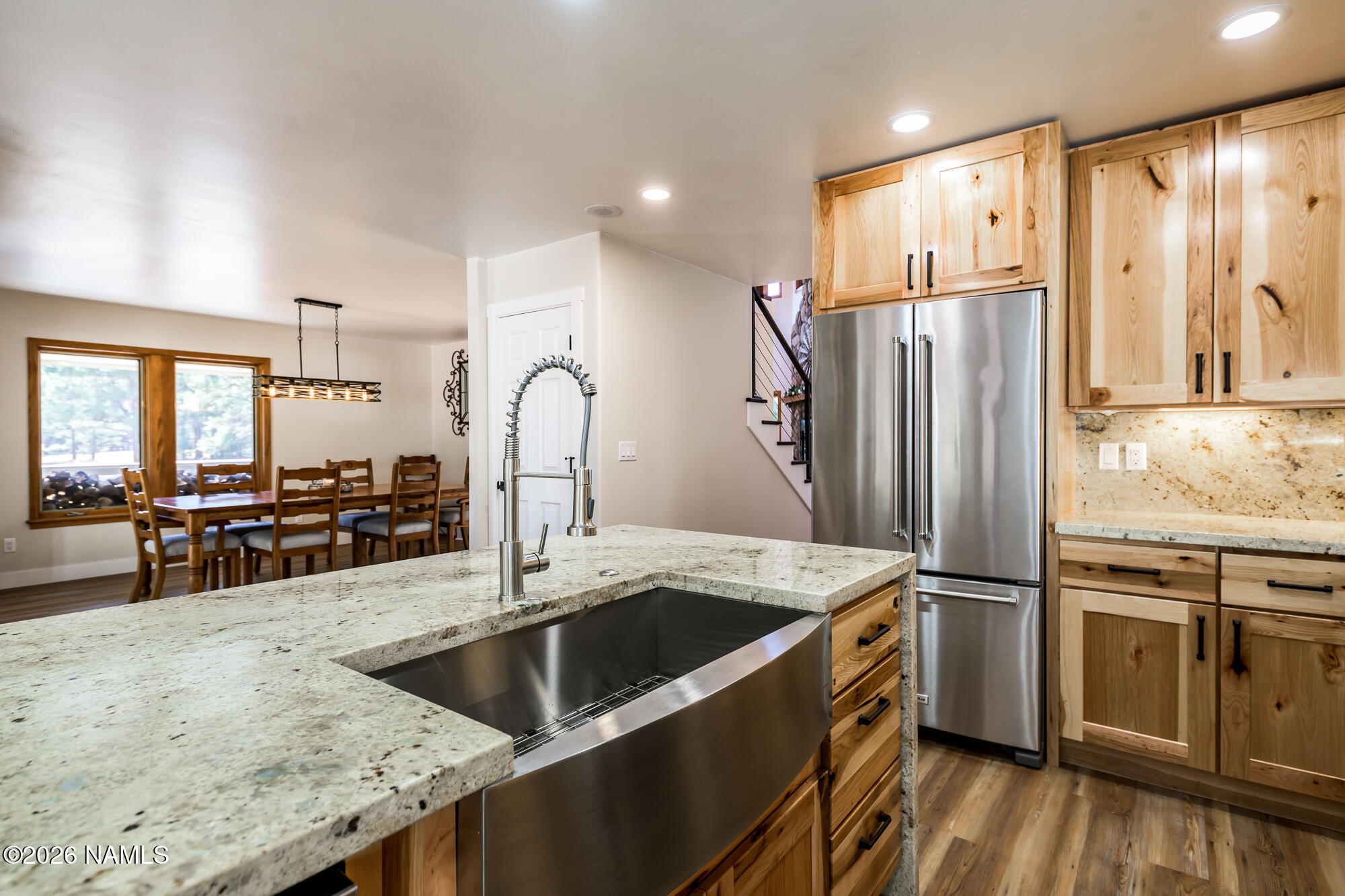 4540 Forest Ranches Loop Parks, AZ 86018 - Photo 9 of 60 a kitchen with stainless steel appliances granite countertop a refrigerator a sink a stove and a wooden floors