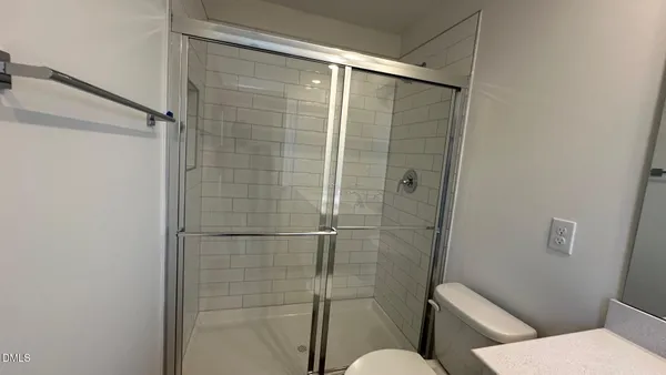 a bathroom with a toilet and a shower