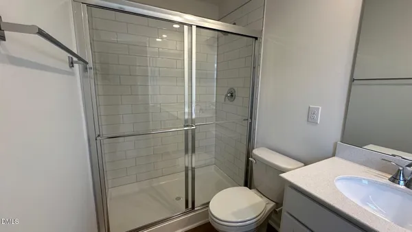 a bathroom with a toilet a sink and shower