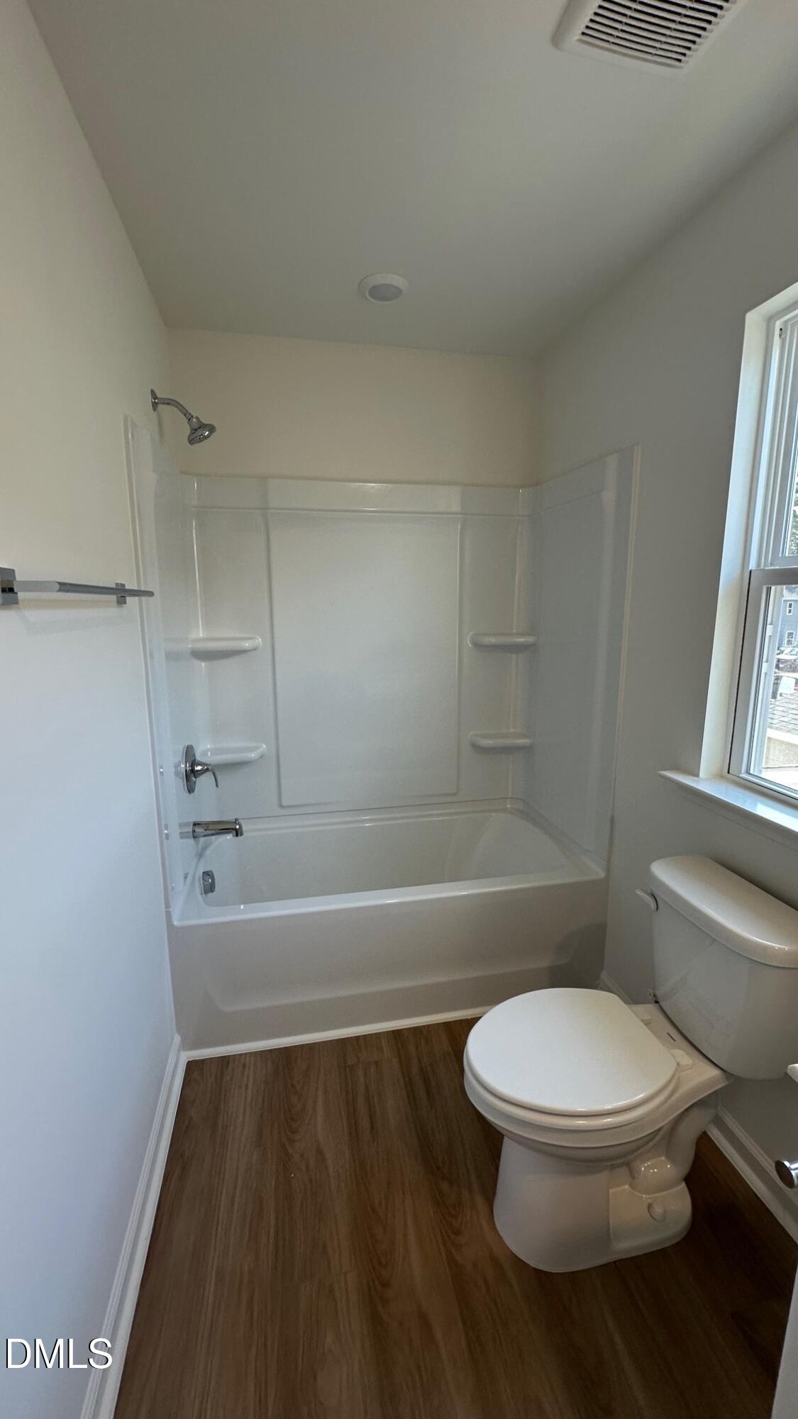 10610 Brookside Reserve Road Raleigh, NC 27614 - Photo 21 of 27 a white toilet and tub sitting next to a bathroom sink