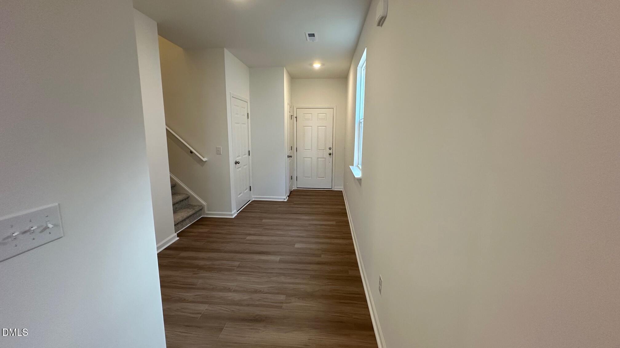 10610 Brookside Reserve Road Raleigh, NC 27614 - Photo 7 of 27 a view of a hallway with wooden floor and staircase