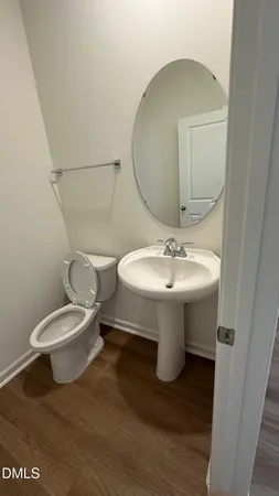 a bathroom with a sink toilet and a mirror