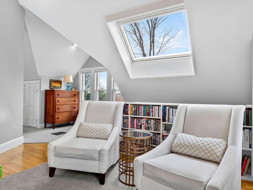 32 Donizetti Street Wellesley, MA 02482 - Photo 11 of 22 a living room with furniture and a book shelf