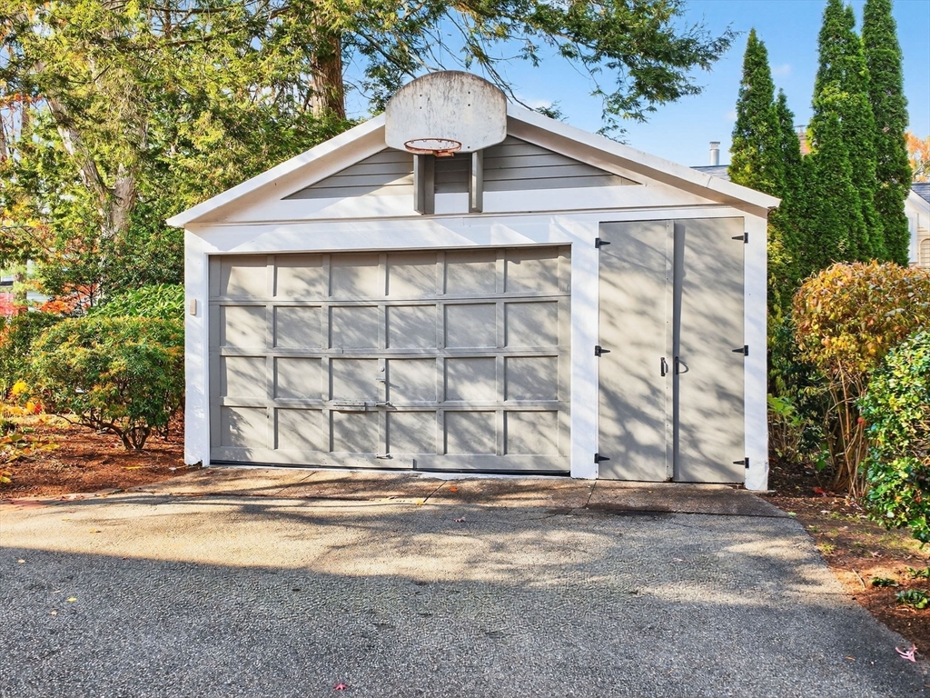 32 Donizetti Street Wellesley, MA 02482 - Photo 18 of 22 a front view of a house with a yard and garage