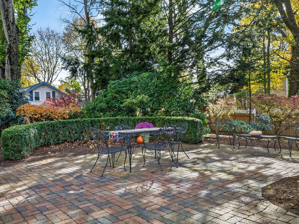 32 Donizetti Street Wellesley, MA 02482 - Photo 20 of 22 a table and chairs sitting in the middle of a yard