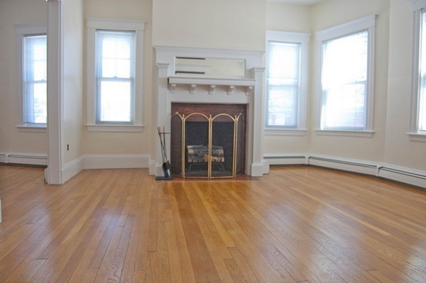 8-10 Kimball Road Watertown, MA 02472 - Photo 11 of 20 an empty room with wooden floor a fireplace and windows
