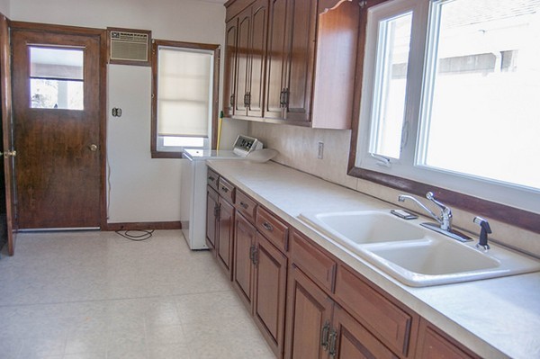 8-10 Kimball Road Watertown, MA 02472 - Photo 14 of 20 a kitchen with stainless steel appliances granite countertop a sink and a window