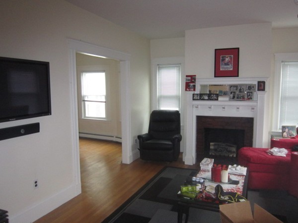 8-10 Kimball Road Watertown, MA 02472 - Photo 5 of 20 a living room with furniture a flat screen tv and a fireplace