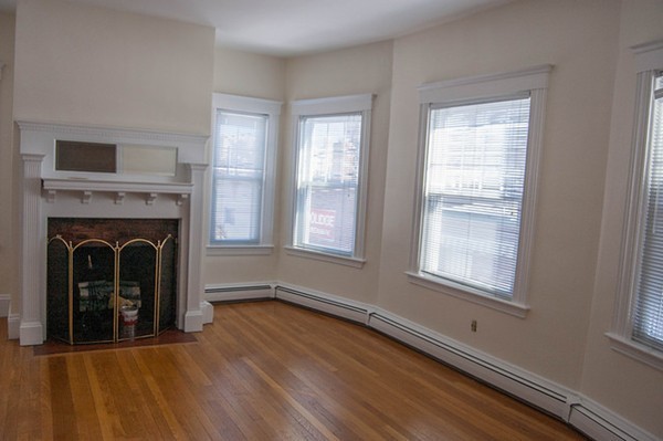 8-10 Kimball Road Watertown, MA 02472 - Photo 9 of 20 a view of an empty room with wooden floor and a window