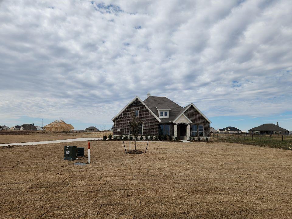 a view of house with outside space and lake view