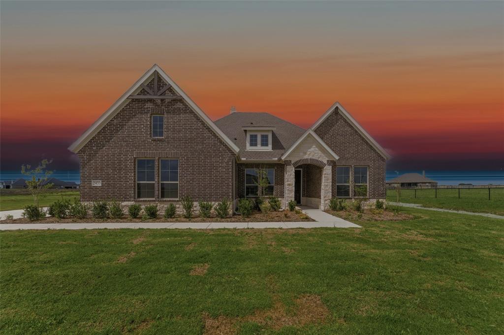 Brick exterior featuring stone accents and a gabled roofline
