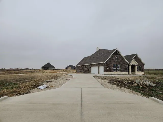 a big house with a big yard and large trees