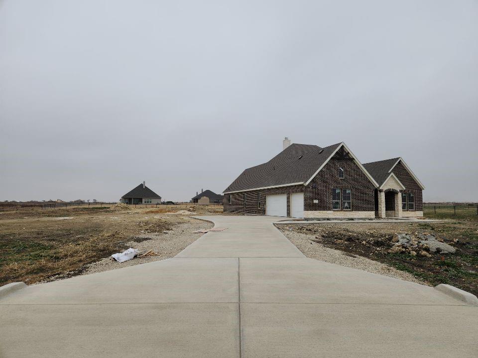 2433 Meteor Drive Krum, TX 76249 - Photo 3 of 12 a big house with a big yard and large trees