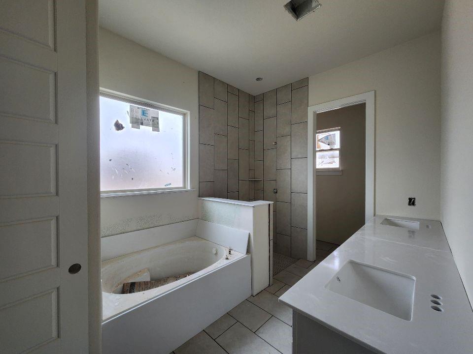 2433 Meteor Drive Krum, TX 76249 - Photo 8 of 12 a bathroom with a tub a sink and a window