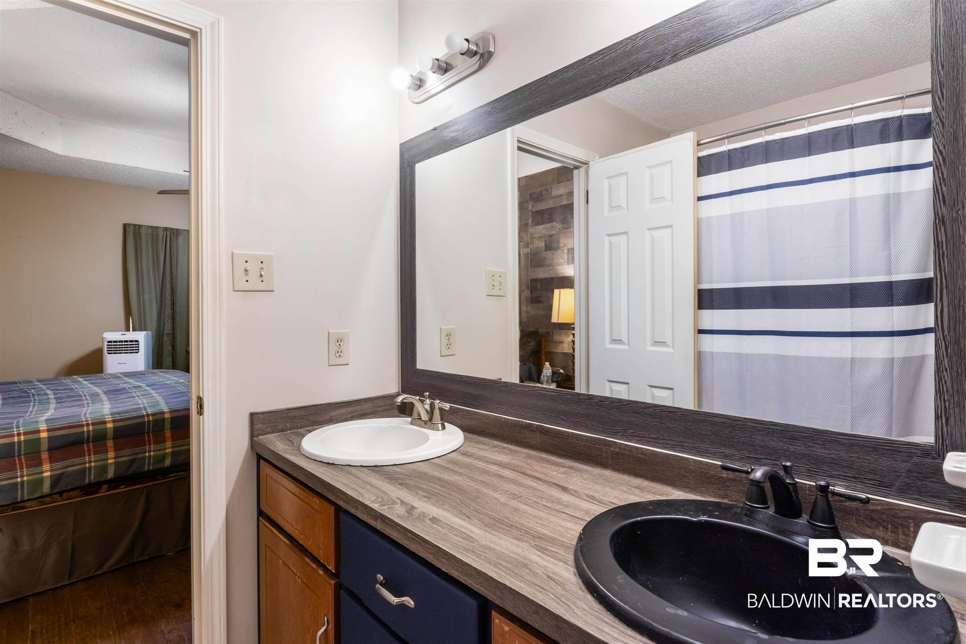 1345 Baker Court Mobile, AL 36695 - Photo 12 of 28 Bathroom featuring hardwood / wood-style flooring and double vanity
