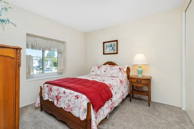 a bedroom with a bed lamp and window