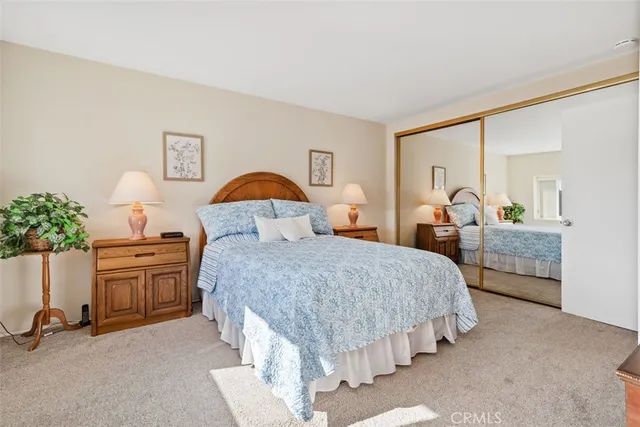 a spacious bedroom with two beds and potted plant