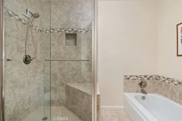 a bathroom with a bathtub and shower