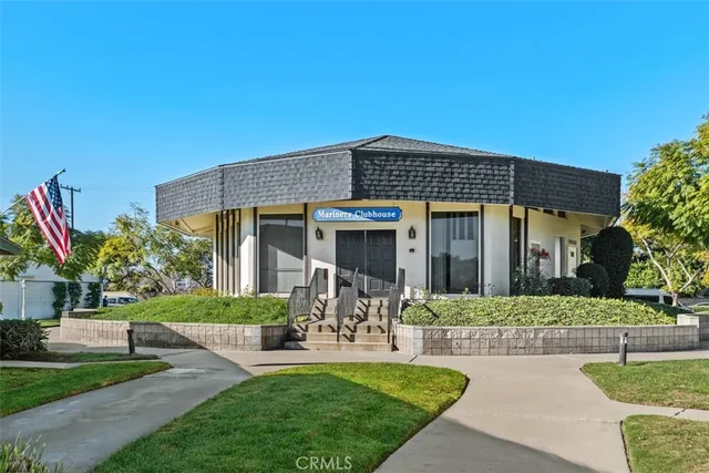a front view of a house with a yard table and chairs