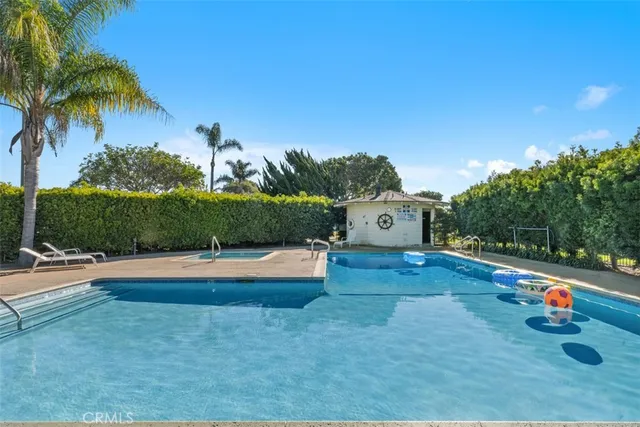 a view of a house with pool and yard