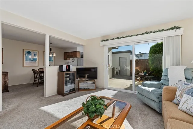 a living room with furniture a fireplace and a table