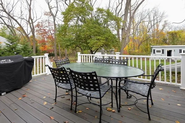 a view of balcony with table and chairs and wooden floor