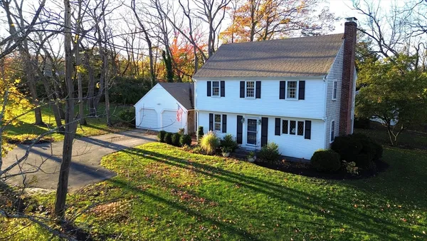 a view of a house with backyard and sitting area