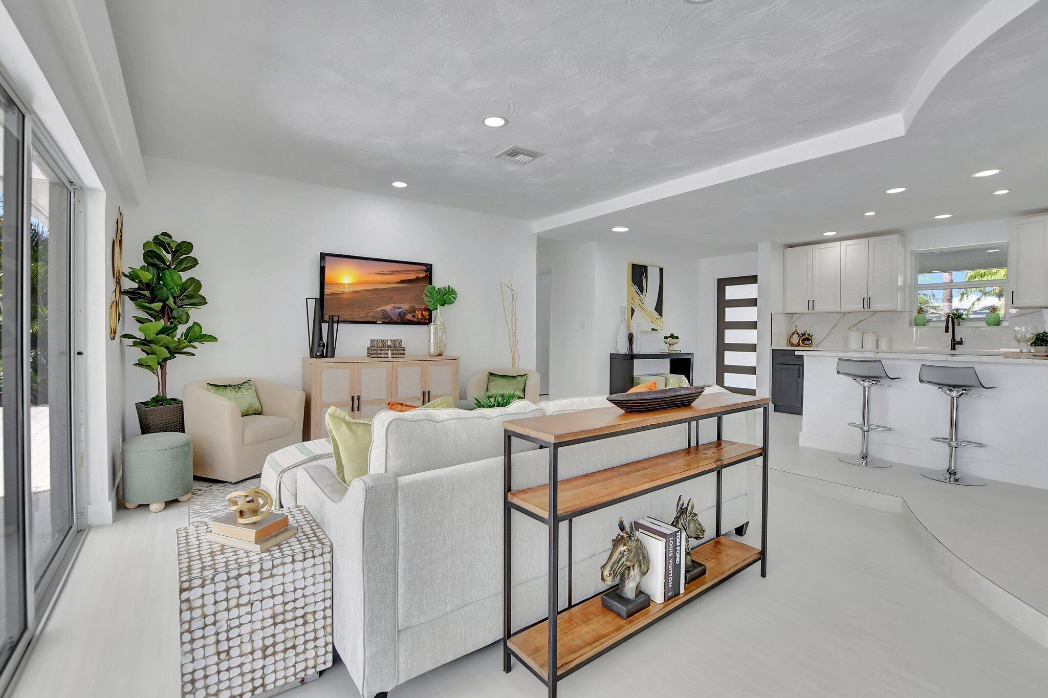 832 Southwest 10th Avenue Boca Raton, FL 33486 - Photo 15 of 57 a living room with furniture a potted plant and kitchen view