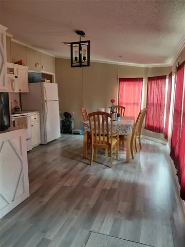 a dining room with furniture and wooden floor