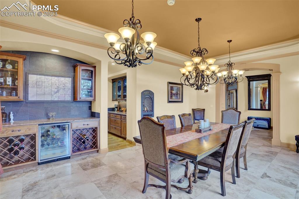 4655 Seton Hall Road Colorado Springs, CO 80918 - Photo 13 of 50 a view of a dining room with furniture and chandelier