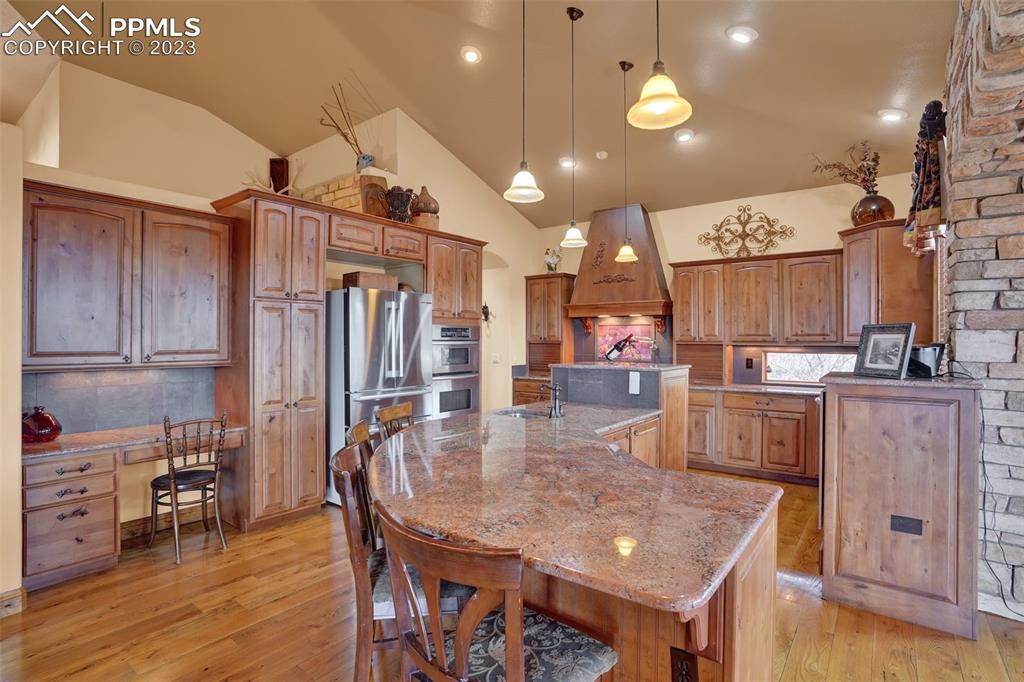 4655 Seton Hall Road Colorado Springs, CO 80918 - Photo 16 of 50 a kitchen with stainless steel appliances granite countertop a table chairs and a refrigerator