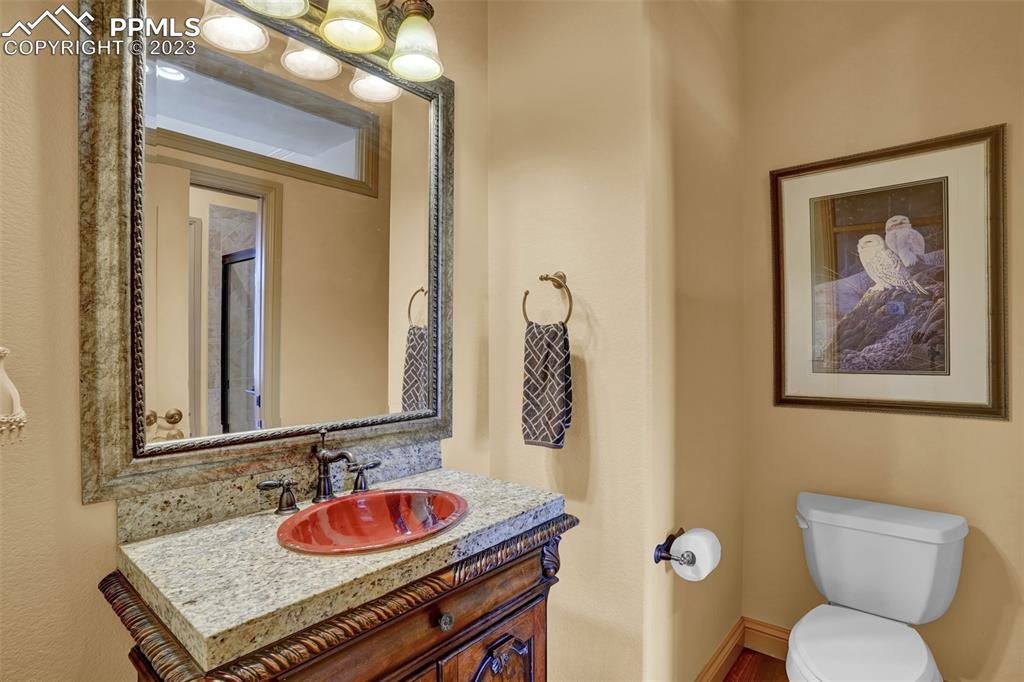4655 Seton Hall Road Colorado Springs, CO 80918 - Photo 23 of 50 a bathroom with a toilet sink and mirror