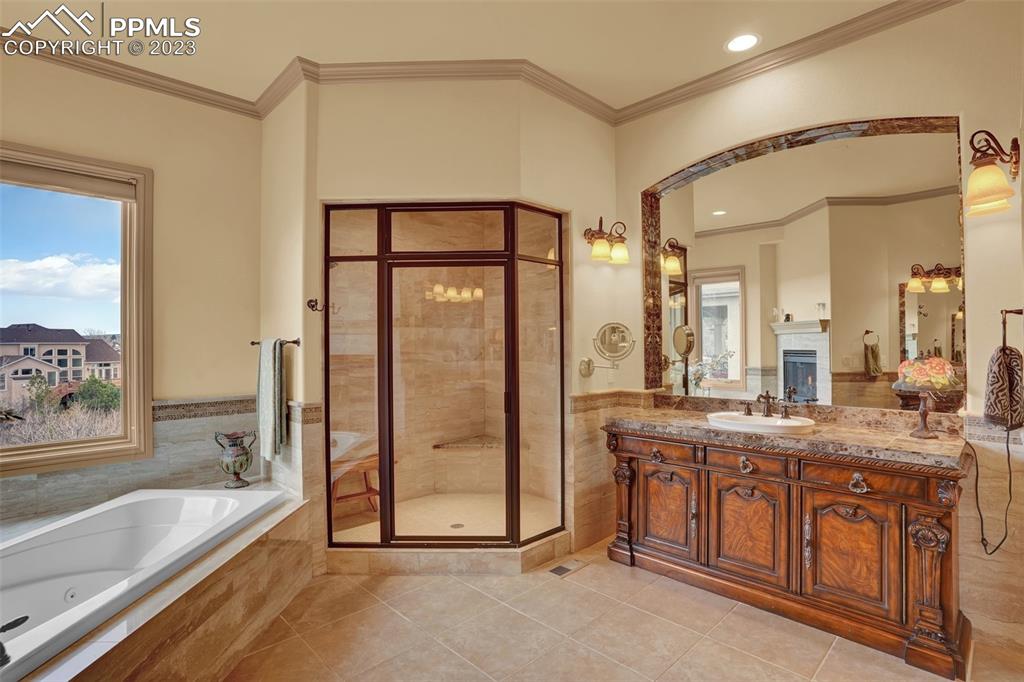 4655 Seton Hall Road Colorado Springs, CO 80918 - Photo 27 of 50 a spacious bathroom with a granite countertop sink mirror and bathtub
