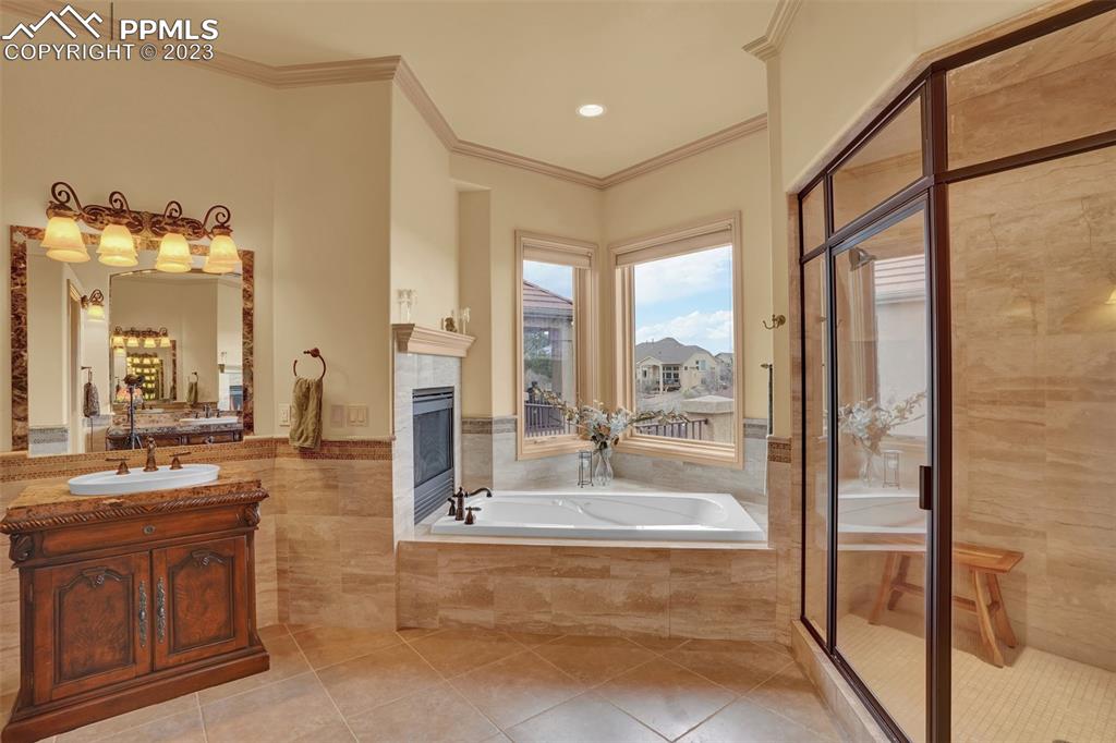 4655 Seton Hall Road Colorado Springs, CO 80918 - Photo 28 of 50 a bathroom with a tub sink and mirror