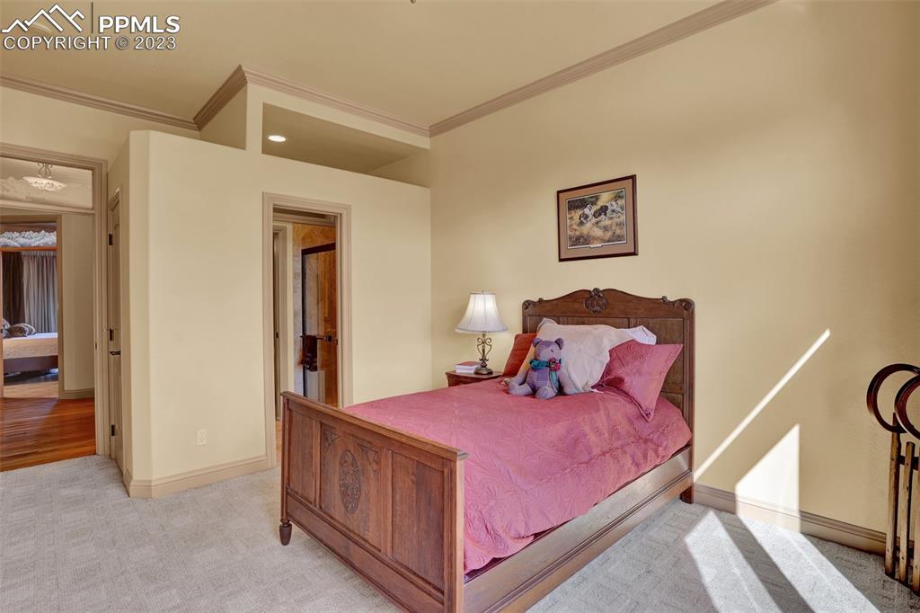 4655 Seton Hall Road Colorado Springs, CO 80918 - Photo 31 of 50 a bedroom with a bed and a lamp with the view of entryway