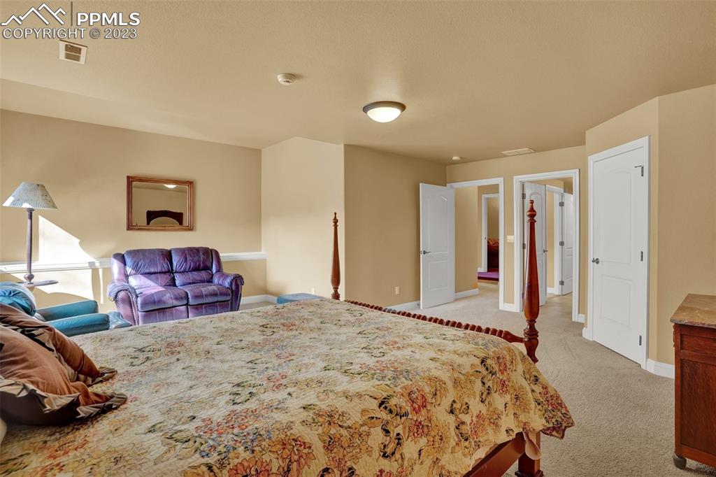 4655 Seton Hall Road Colorado Springs, CO 80918 - Photo 32 of 50 a spacious bedroom with a bed and a view of bedroom