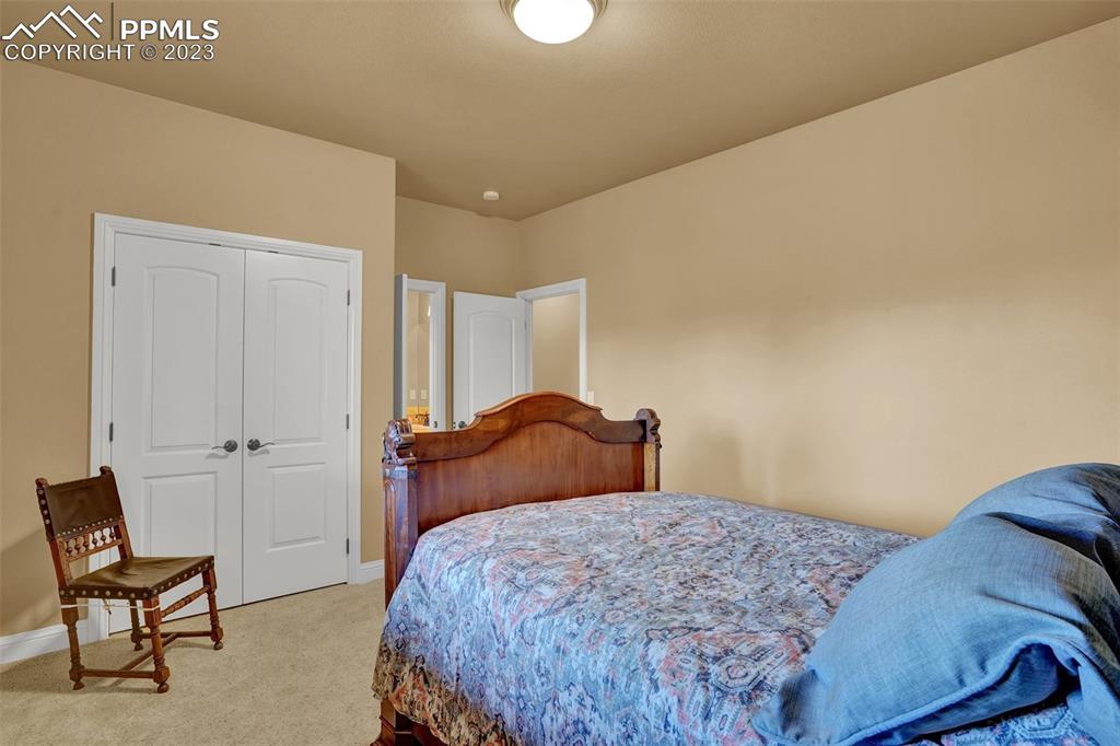 4655 Seton Hall Road Colorado Springs, CO 80918 - Photo 34 of 50 a bedroom with a bed and chair