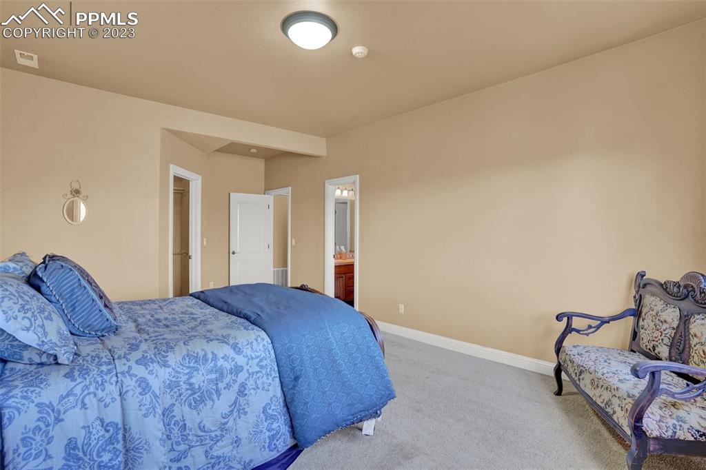 4655 Seton Hall Road Colorado Springs, CO 80918 - Photo 35 of 50 a bedroom with a bed and a dresser