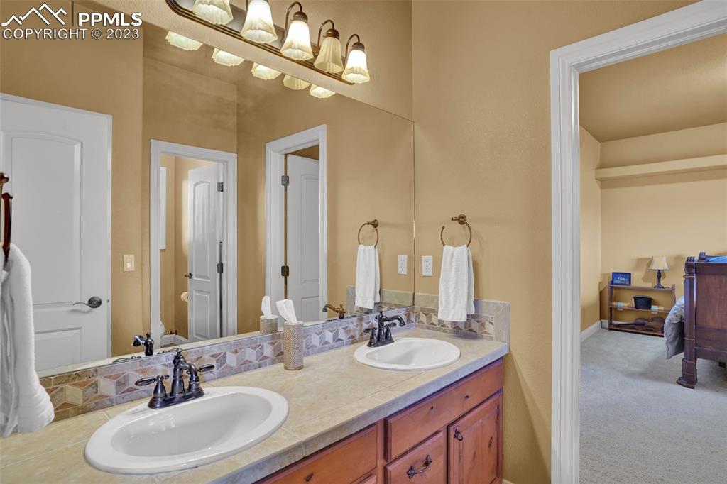 4655 Seton Hall Road Colorado Springs, CO 80918 - Photo 36 of 50 a bathroom with a double vanity sink and a mirror
