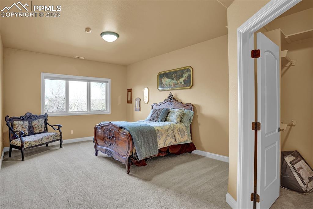 4655 Seton Hall Road Colorado Springs, CO 80918 - Photo 37 of 50 a spacious bedroom with a bed and a couch