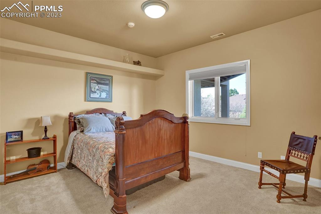 4655 Seton Hall Road Colorado Springs, CO 80918 - Photo 39 of 50 a bedroom with a bed and a lamp