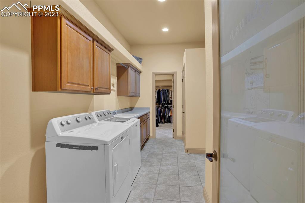 4655 Seton Hall Road Colorado Springs, CO 80918 - Photo 40 of 50 a utility room with cabinets washer and dryer