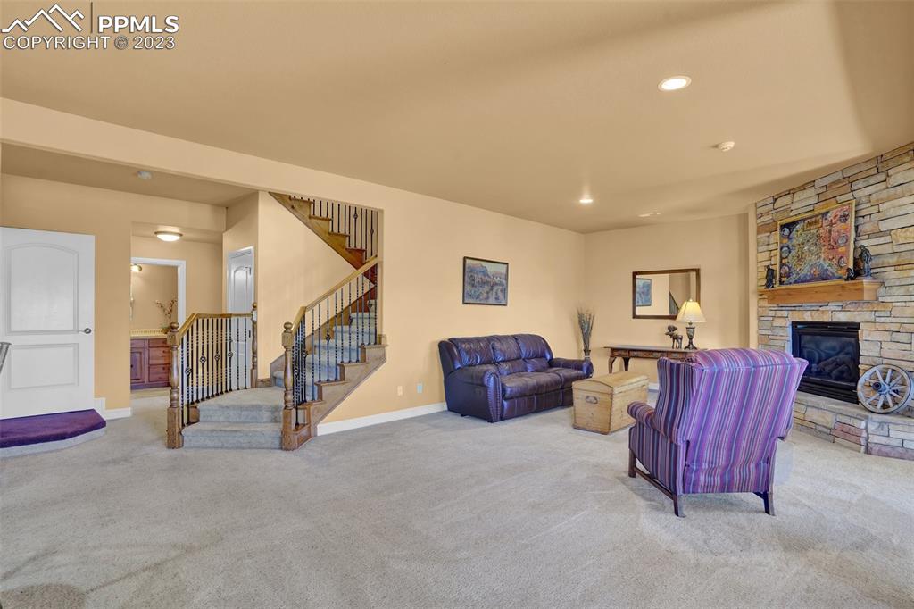 4655 Seton Hall Road Colorado Springs, CO 80918 - Photo 41 of 50 a living room with furniture gym equipment and a fireplace