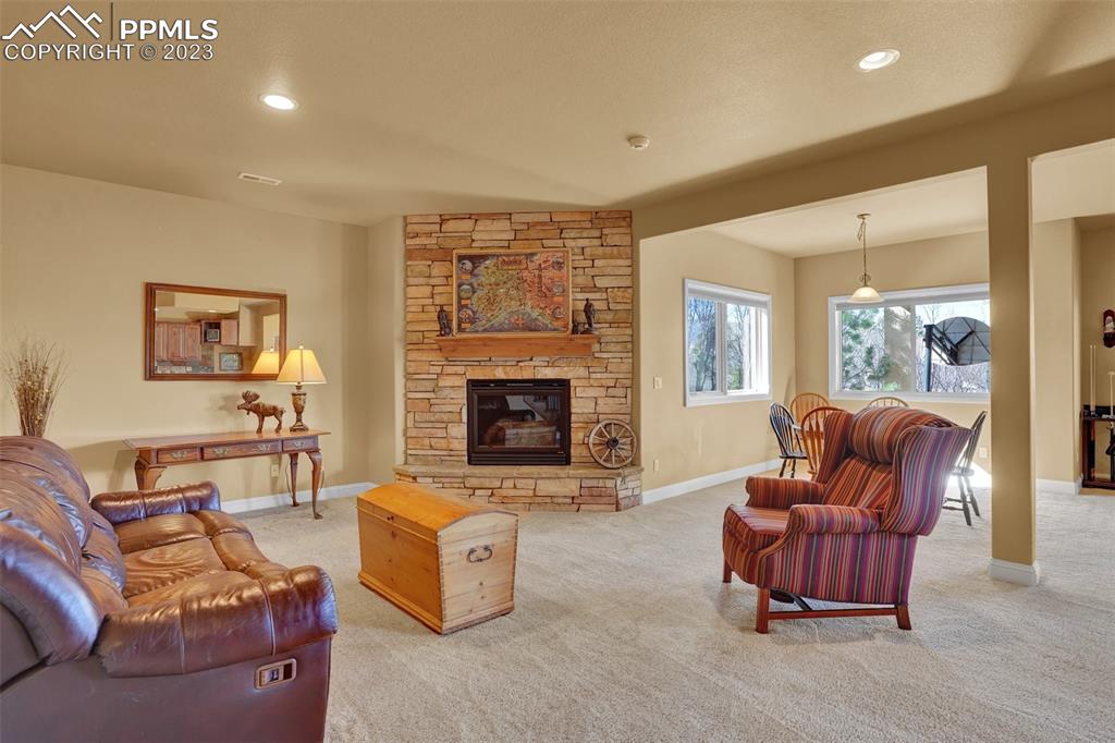 4655 Seton Hall Road Colorado Springs, CO 80918 - Photo 42 of 50 a living room with furniture and a fireplace