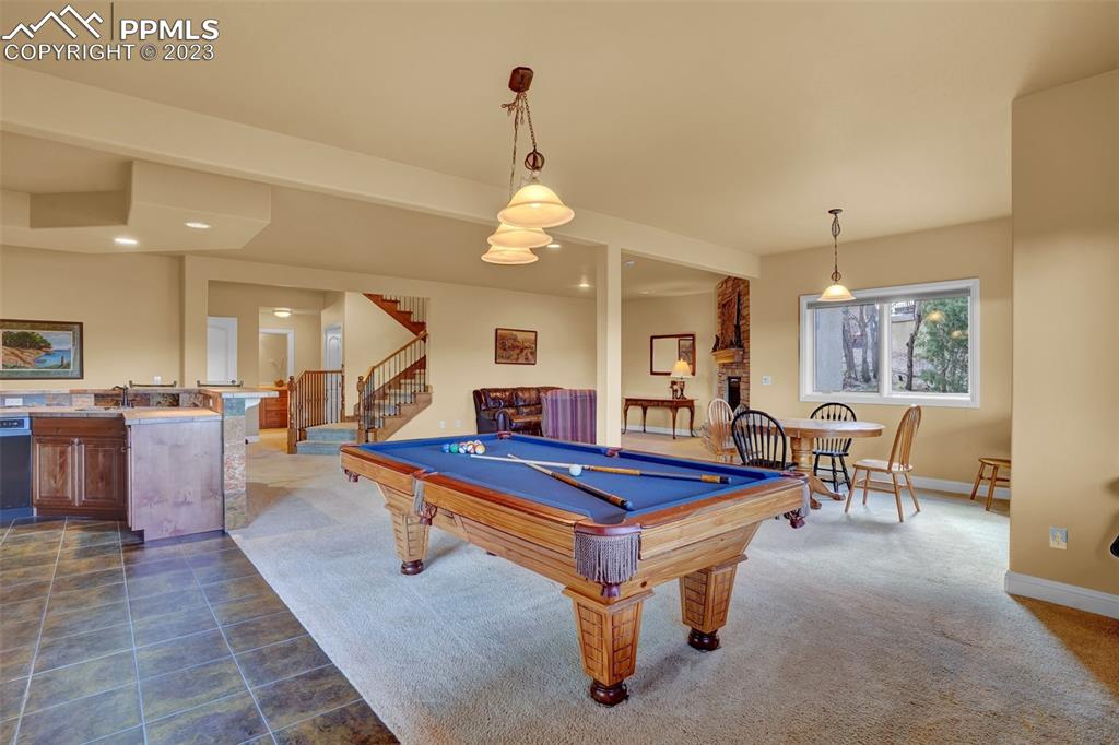 4655 Seton Hall Road Colorado Springs, CO 80918 - Photo 45 of 50 a dining hall with couches a table and chairs with wooden floor