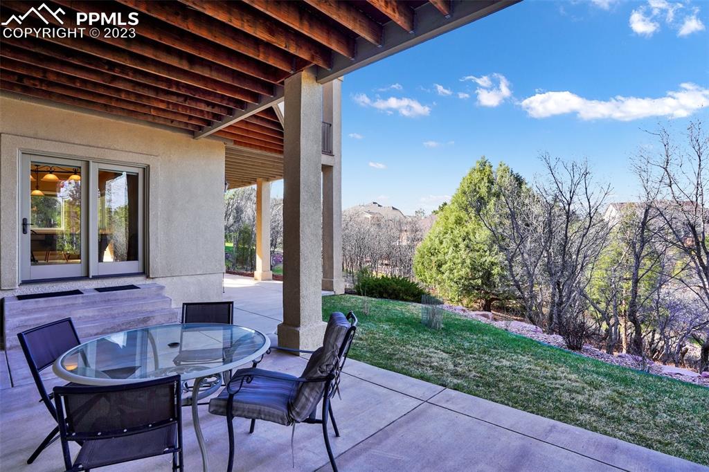 4655 Seton Hall Road Colorado Springs, CO 80918 - Photo 48 of 50 a view of a patio with table and chairs and potted plants
